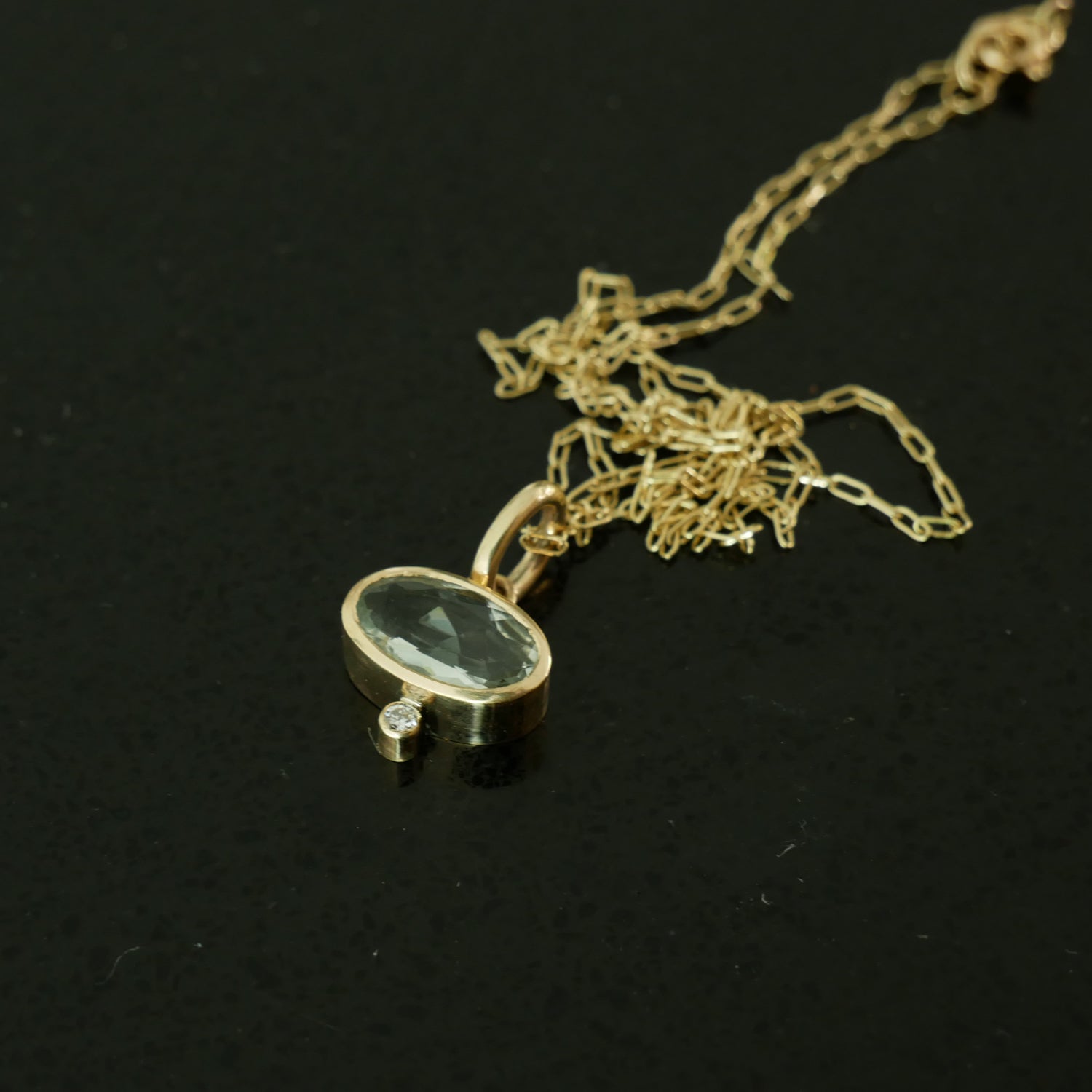 Praisalite and diamond gold pendant