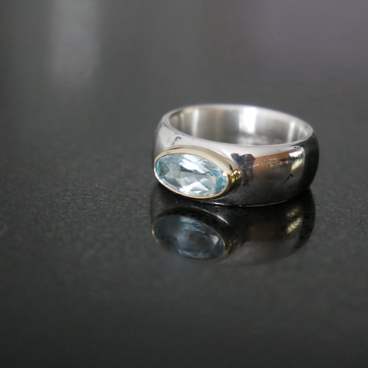 Wide silver and gold ring with oval Topaz