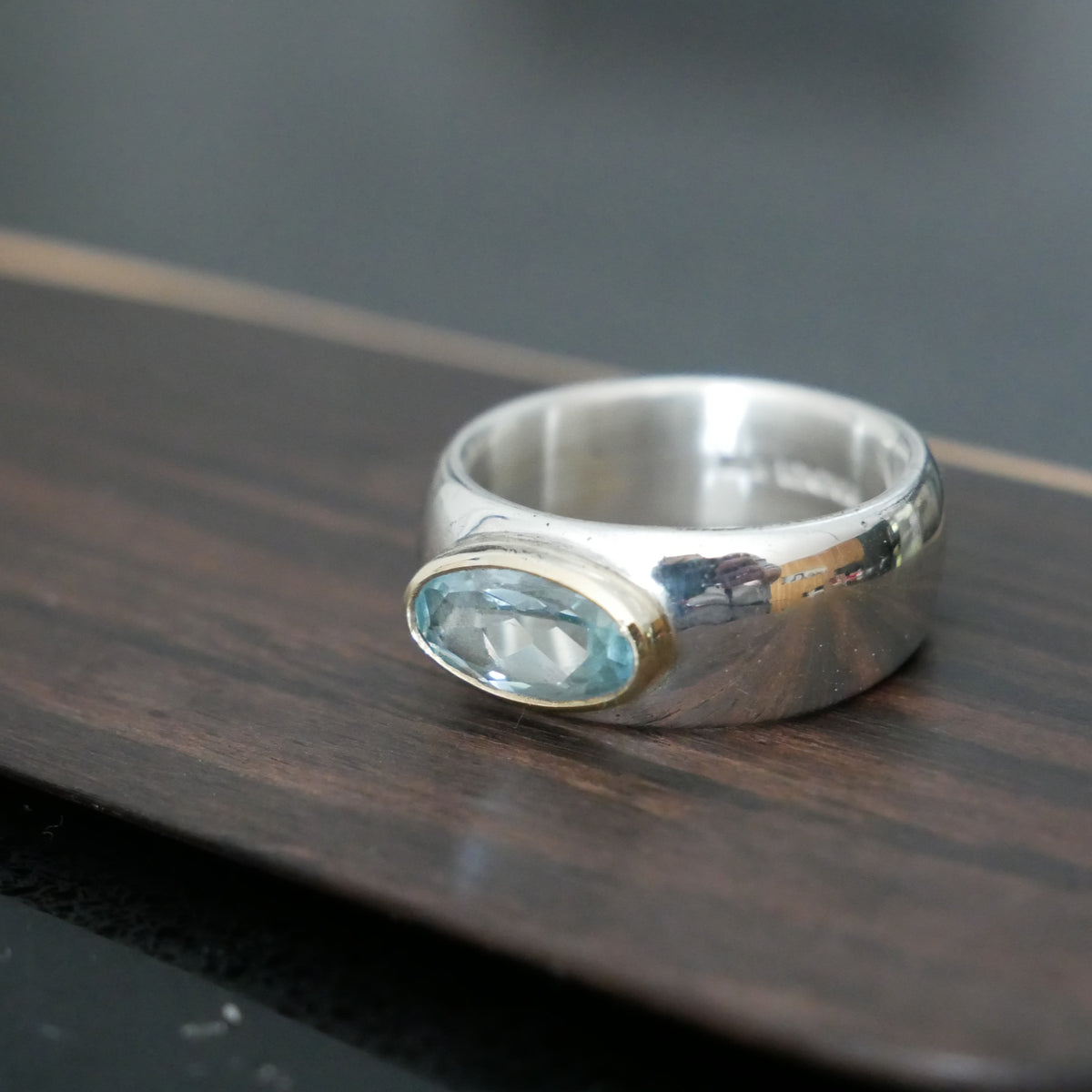 Wide silver and gold ring with oval Topaz