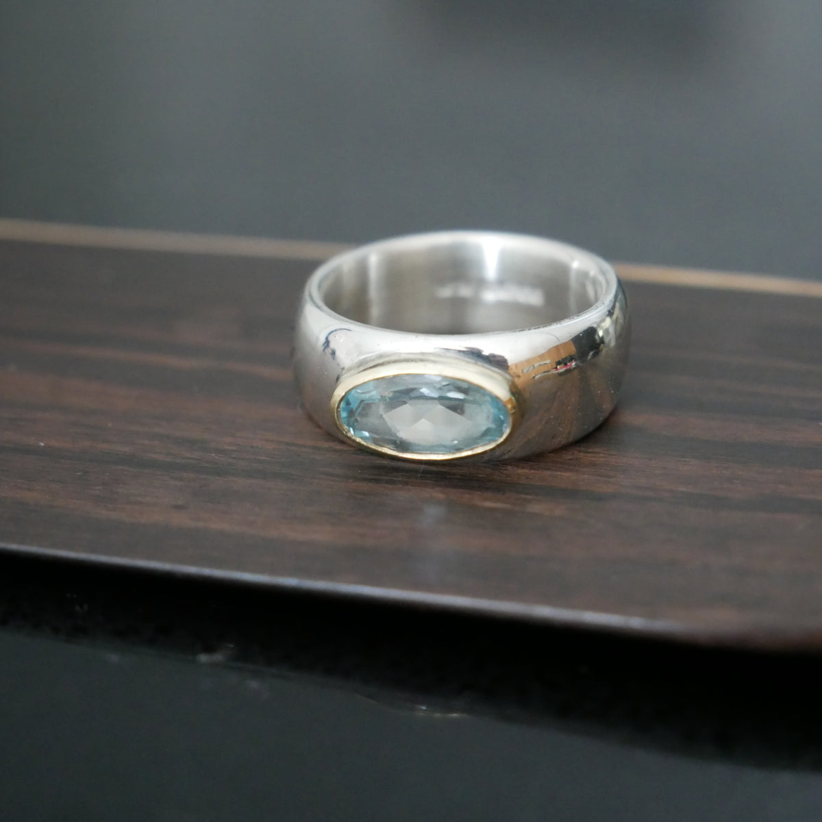 Wide silver and gold ring with oval Topaz