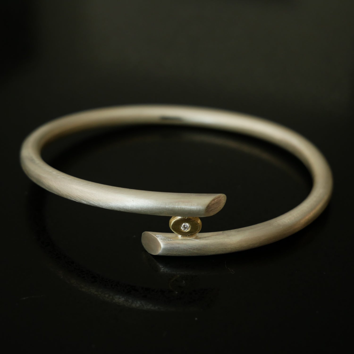 Chunky silver bangle with gold and diamond detail