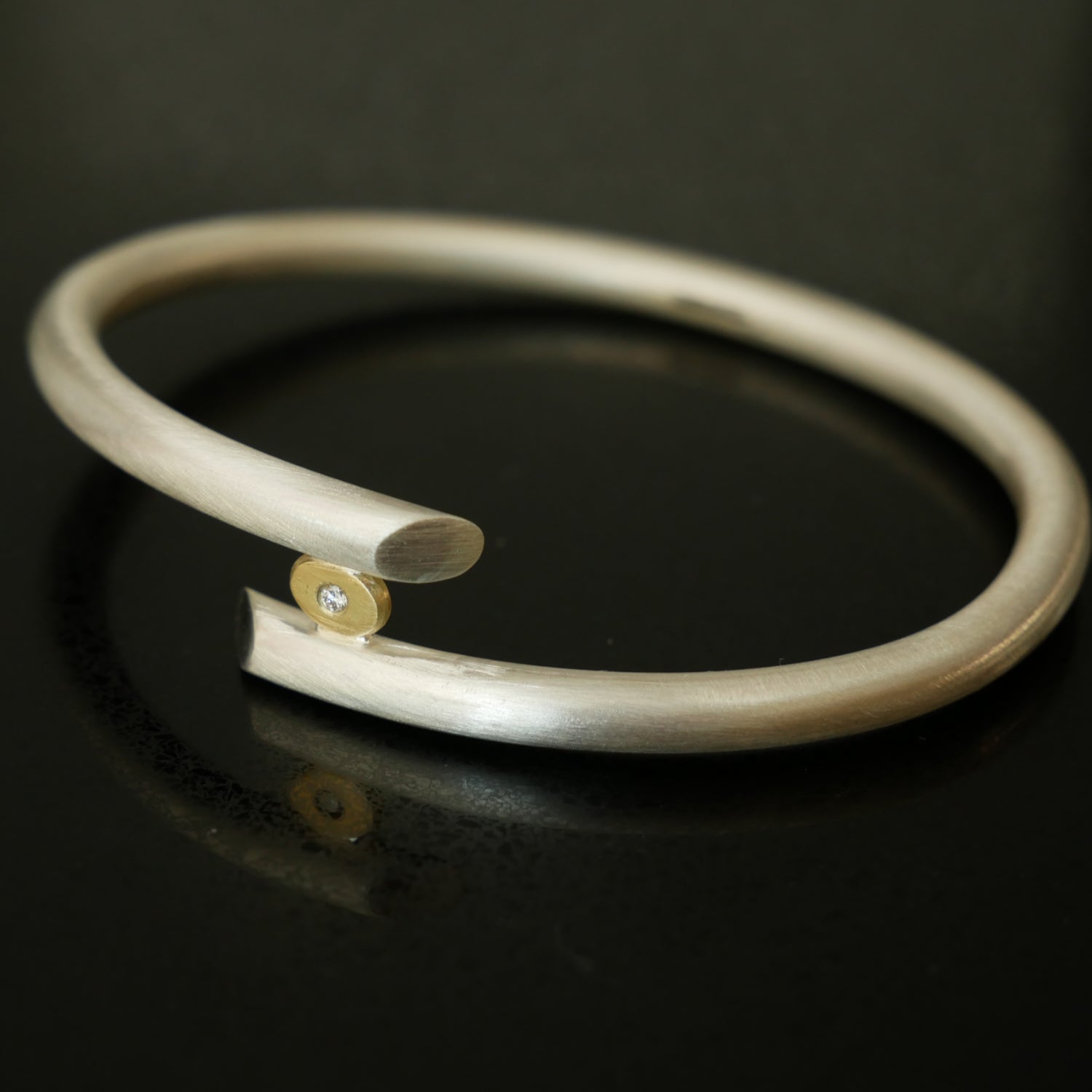 Chunky silver bangle with gold and diamond detail