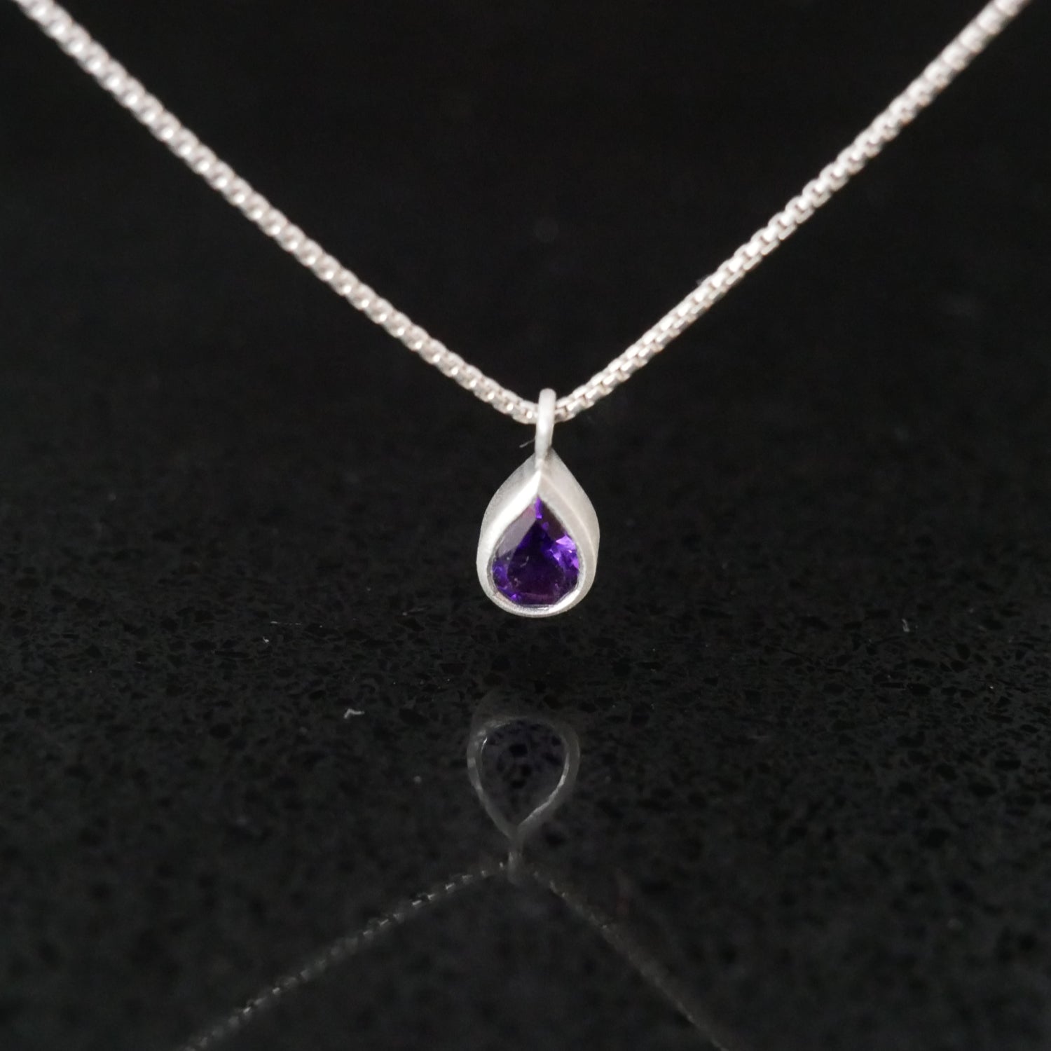 Teardrop-shaped amethyst pendant on a silver chain