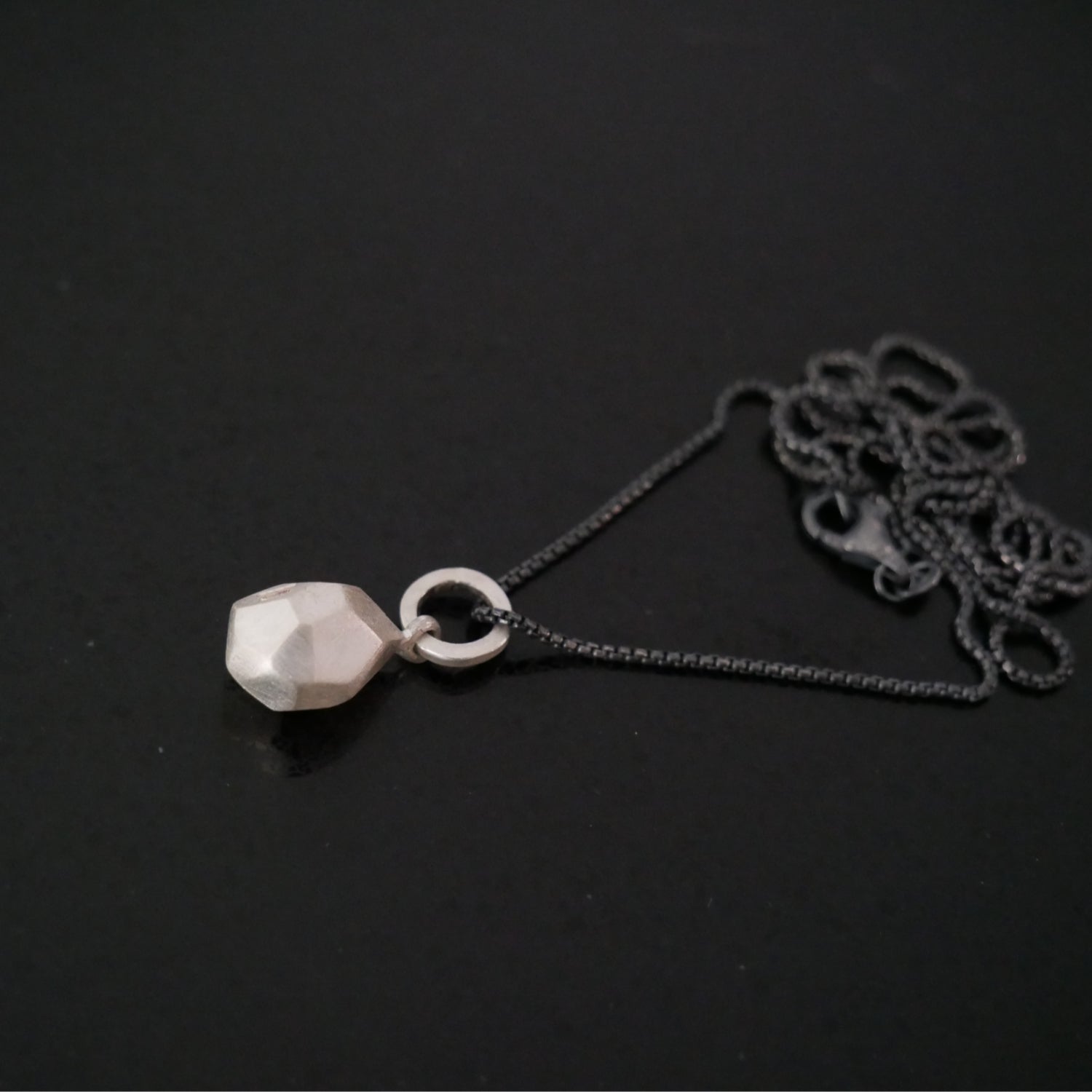facetted silver pendant on oxydised chain
