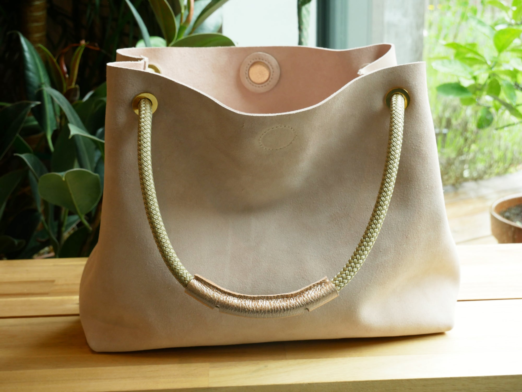 pink suede shoulder and rope bag