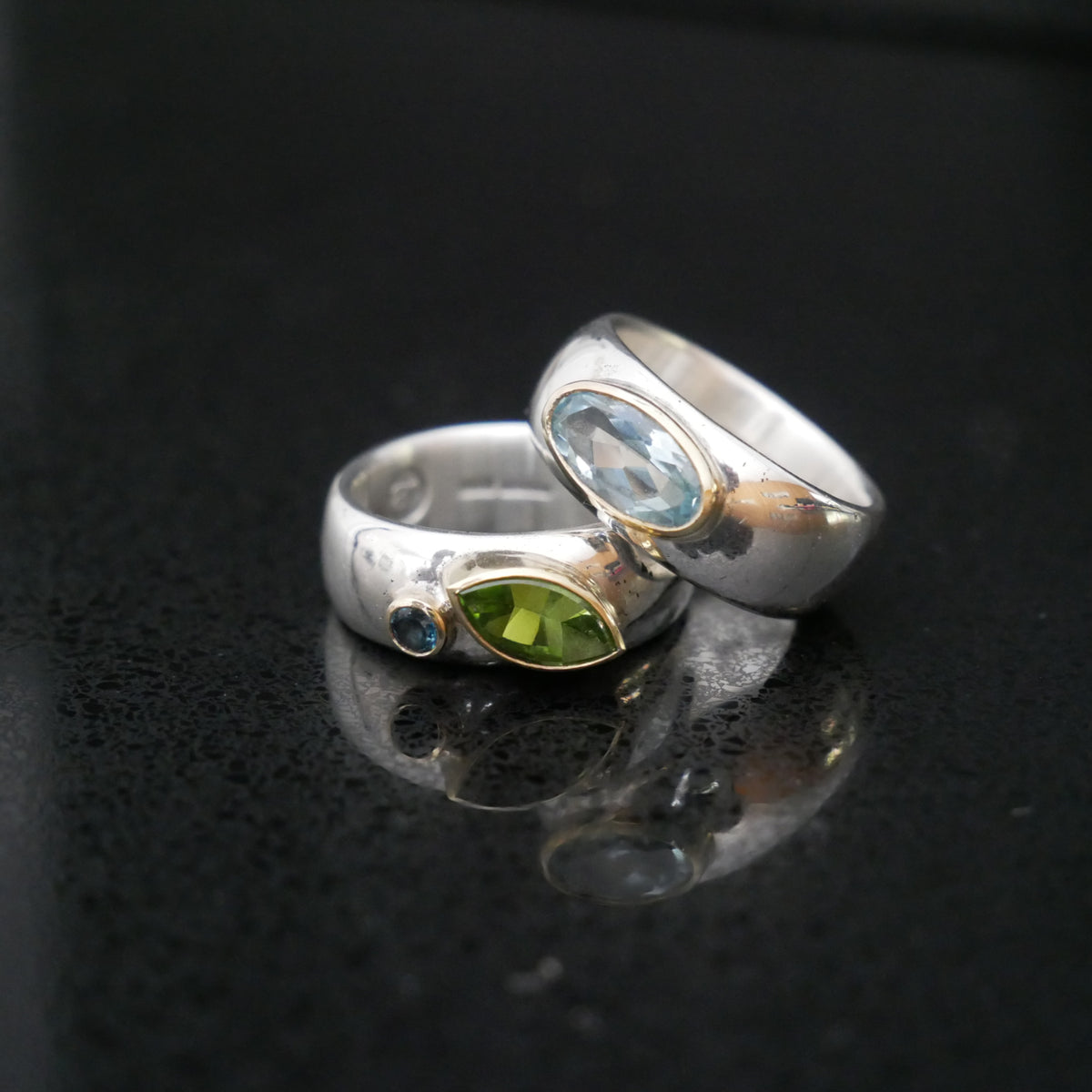 Wide silver and gold ring with oval Topaz