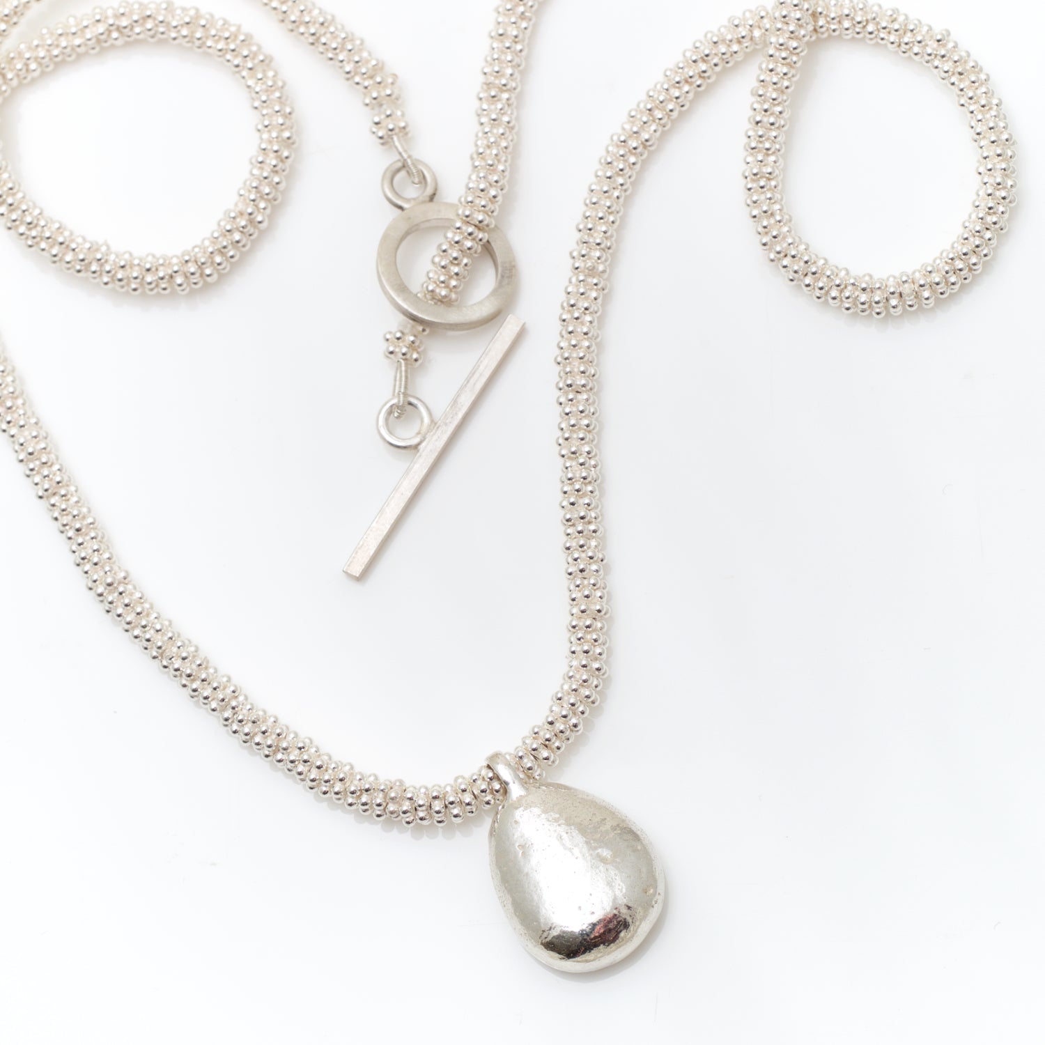 silver granulated necklace with pebble charm