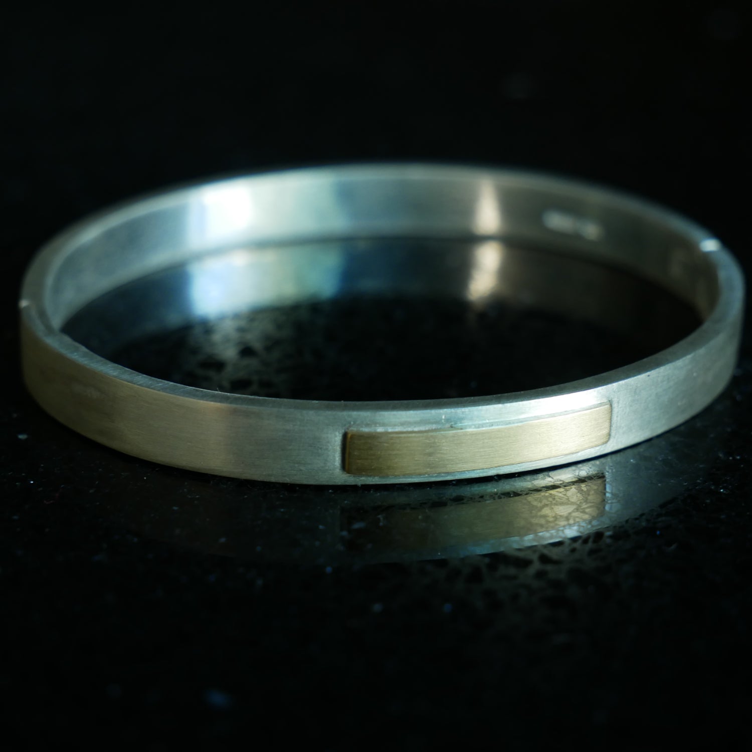 silver and gold hinged bracelet