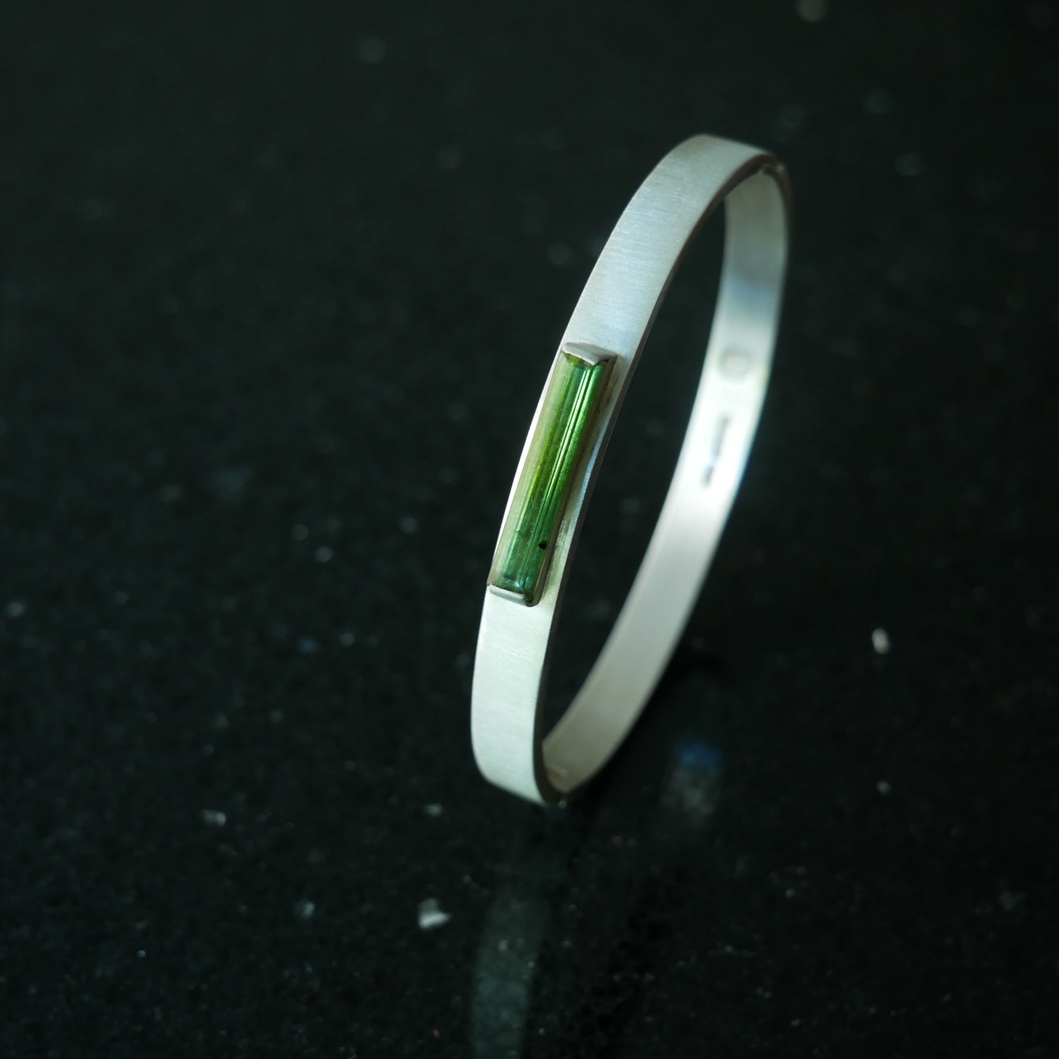 Silver hinged bracelet with green tourmaline