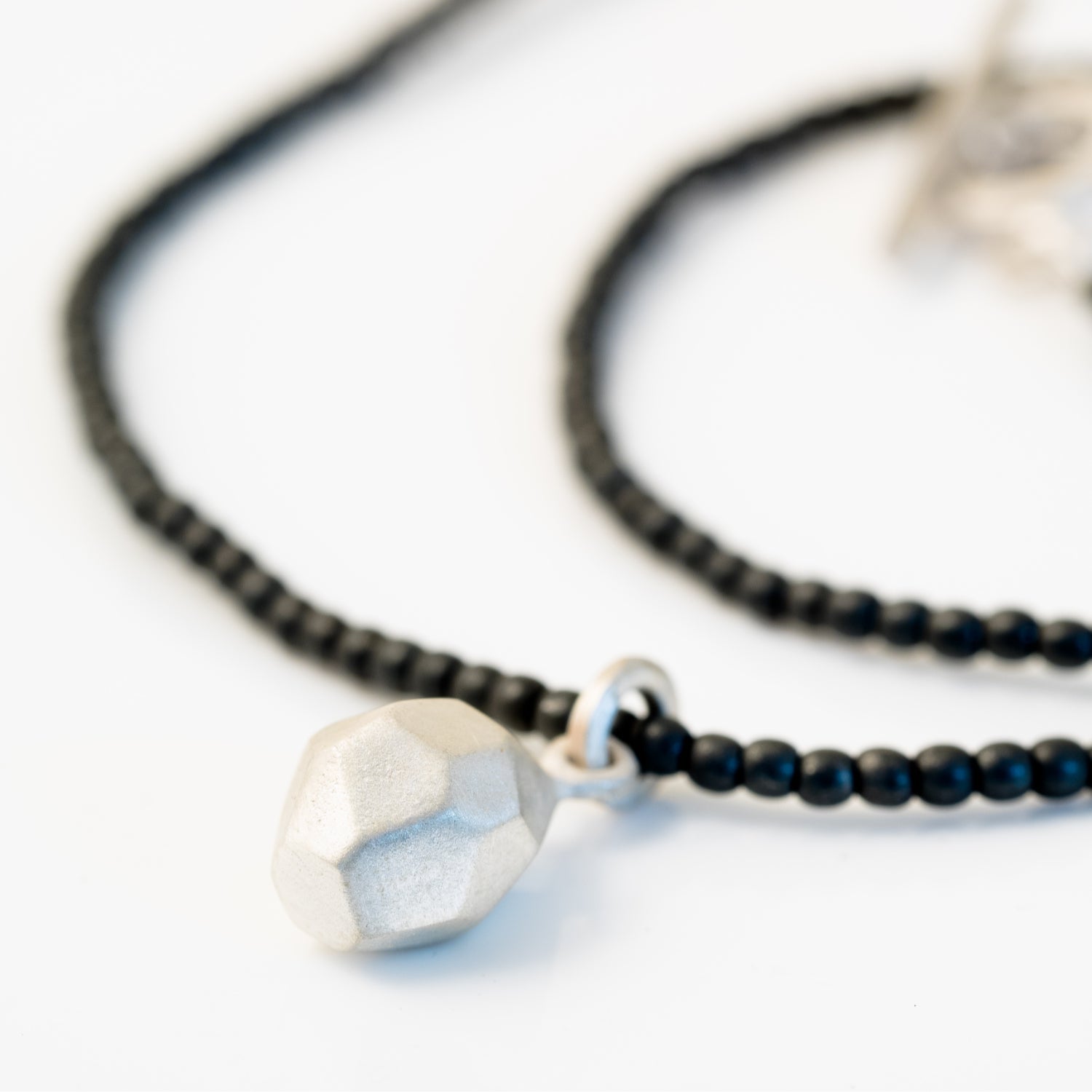 Haematite necklace with Flint charm