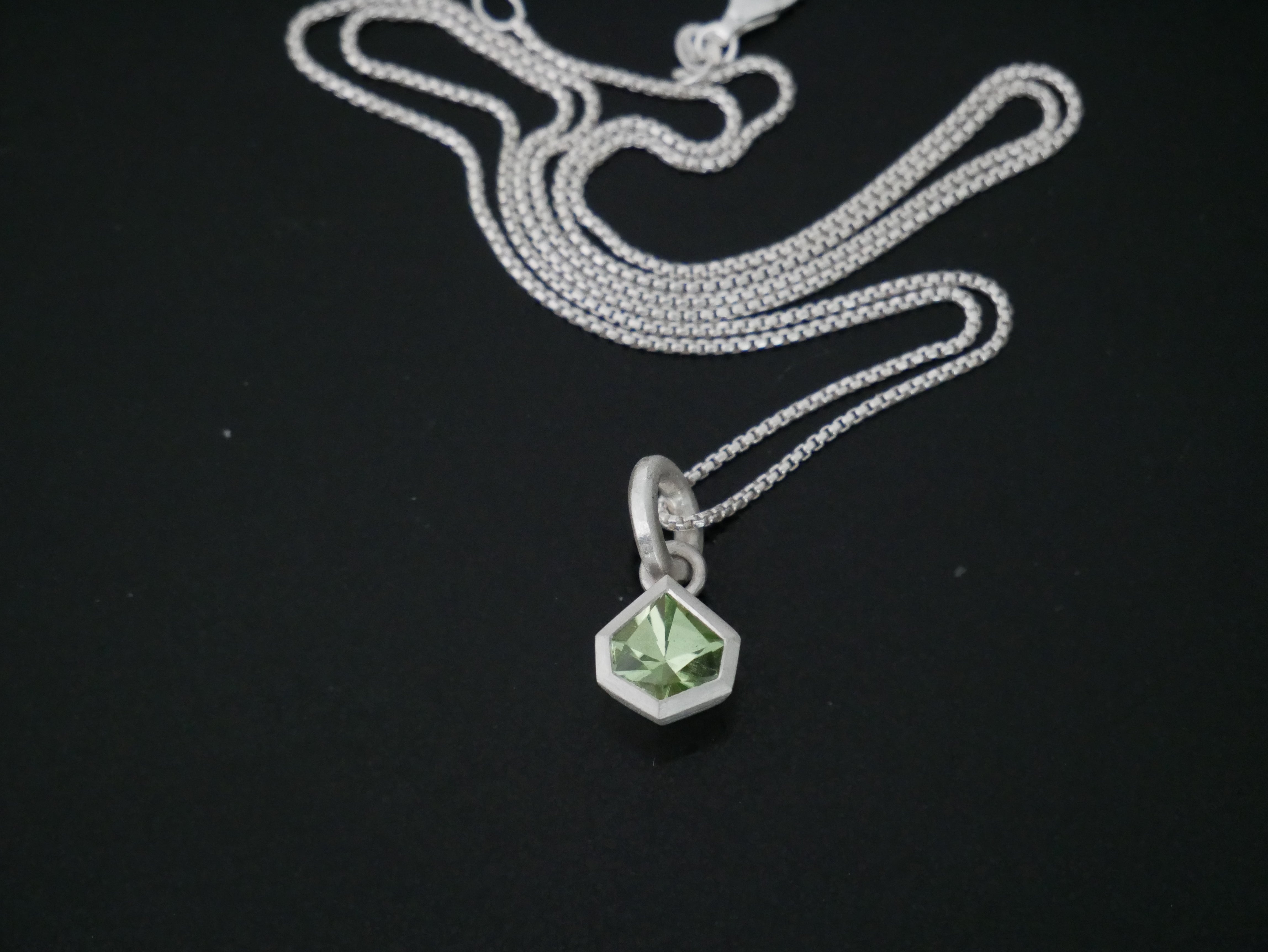silver pendant with geometric peridot