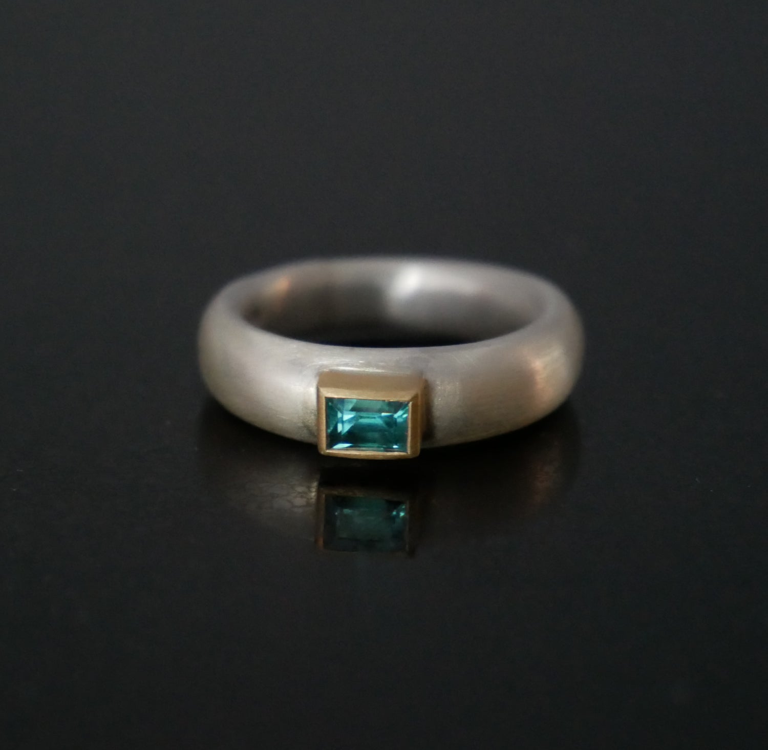 silver ring with zircon set in gold