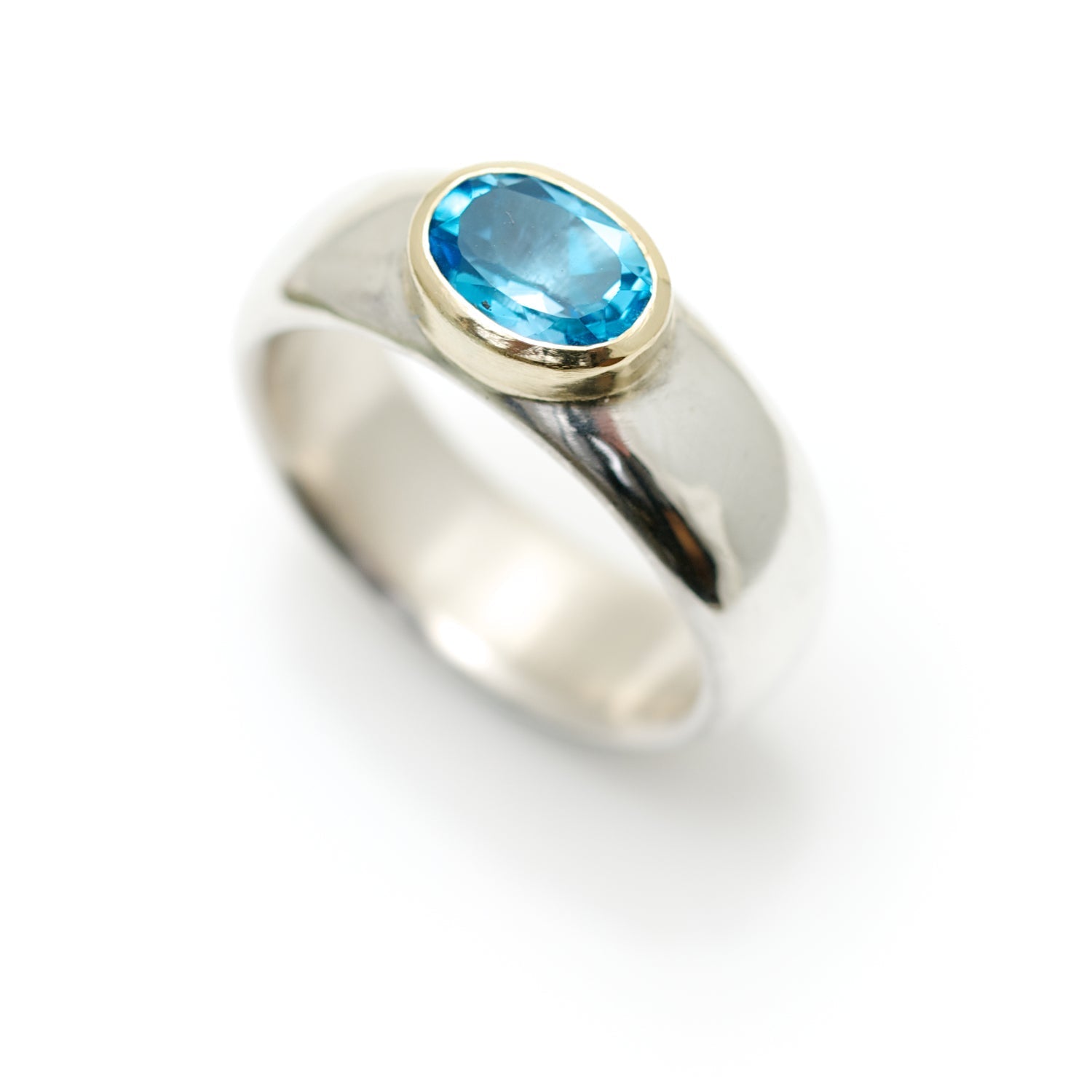 Wide silver ring with topaz set in 18ct gold