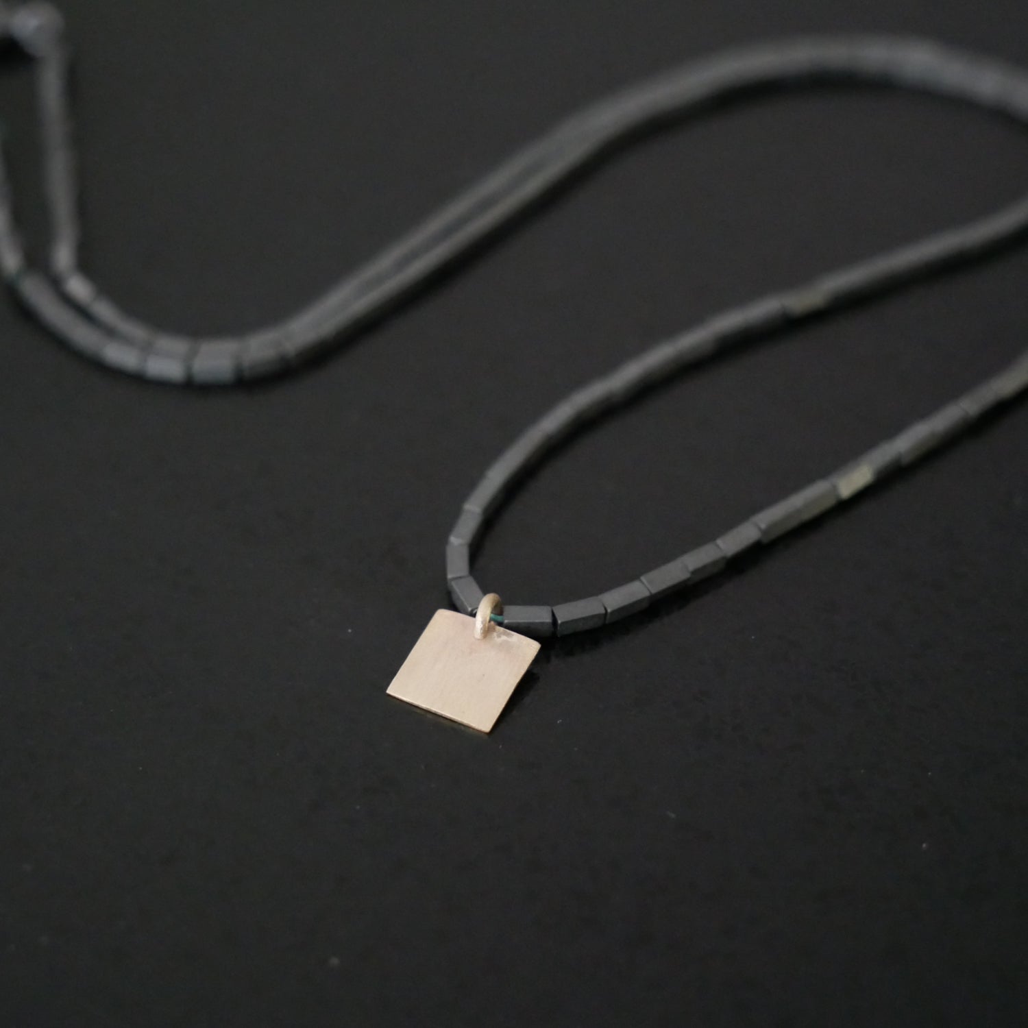 Delicate bead necklace with 9ct gold square