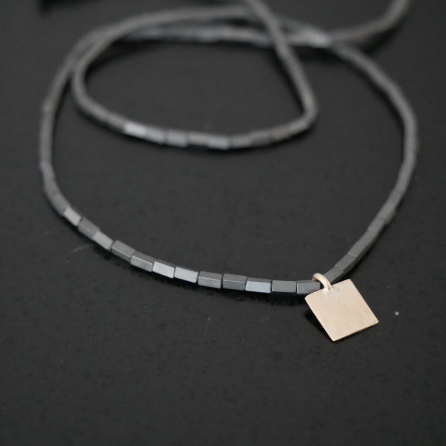 Delicate bead necklace with 9ct gold square