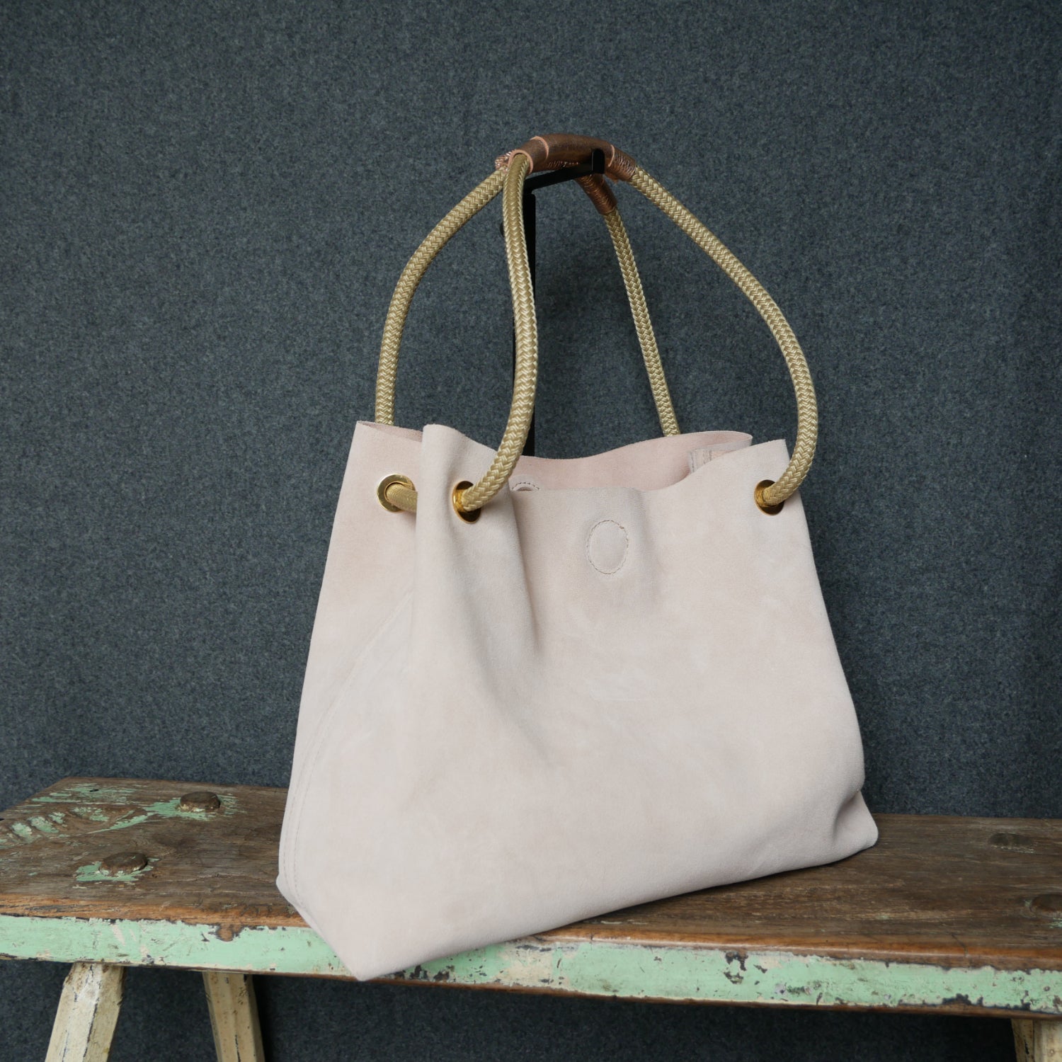 pink suede shoulder bag with cord handle