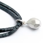 Square Haematite bead bracelet with silver geometric charm