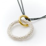 silver beaded circular necklace with gold plate and oxydised ball chain