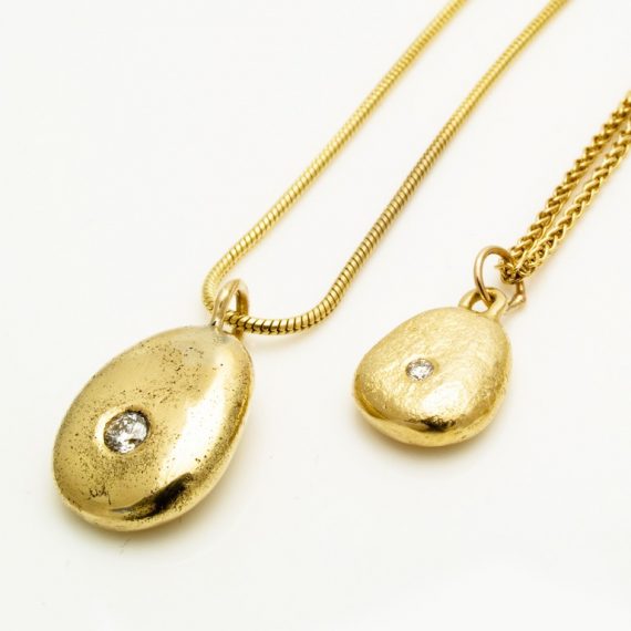 Medium and small gold pebble necklaces on 9ct chain with tiny flush set diamonds