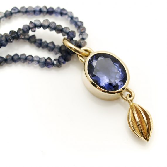 Oval Iolite facetted pendant set in 9ct gold on a double row of Iolite beads