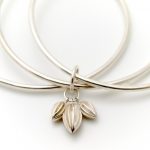 Triple silver bangle with seed pod charms