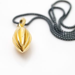 medium gold plated pod necklace on oydised silver chain still shot 1