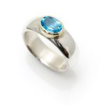 Wide silver ring with a Swiss Blue Topaz set in 18ct gold