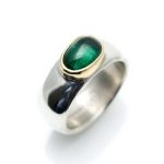 Wide silver ring with a green tourmaline set in 18ct gold