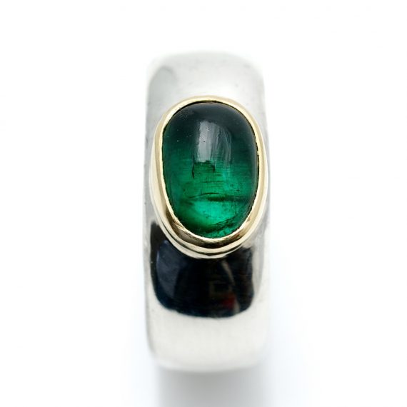 Wide silver ring with a green tourmaline set in 18ct gold