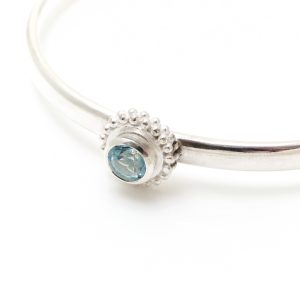 Simple silver cuff with semi precious stone and a beaded ring surround