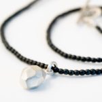 haematite bead necklace with silver geometric charm