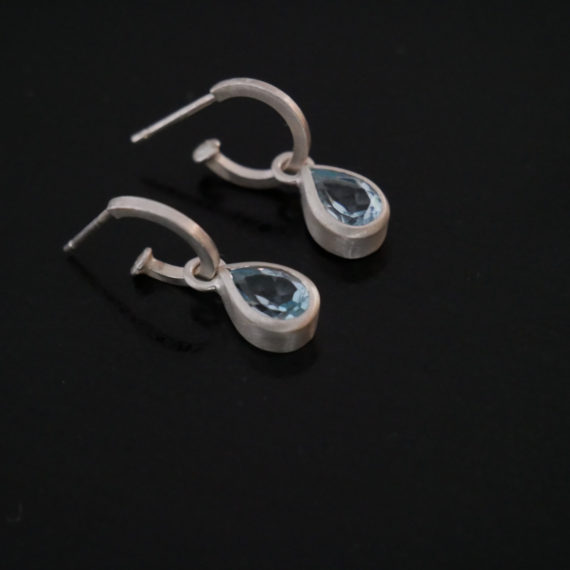 silver hoop earring with topaz drop