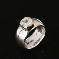 wide silver and gold ring with cubic zirconium