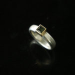 Silver and gold ring with green sapphire